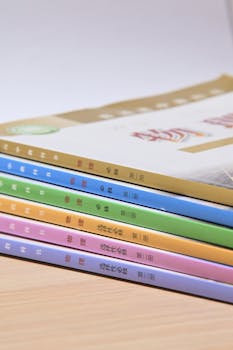 A neatly arranged stack of colorful books on a wooden surface, ideal for educational themes.