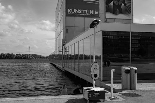 Black and white photo of modern architecture by a waterfront in Almere, Netherlands.