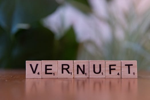 Close-up of Scrabble tiles arranged to spell 'Vernuft' on a wooden surface with blurred background.