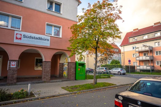 Explore a picturesque autumn street in Lower Saxony, Germany with vibrant trees.