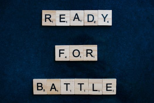 Scrabble tiles spell 'Ready for Battle' on a blue background, symbolizing motivation and readiness.
